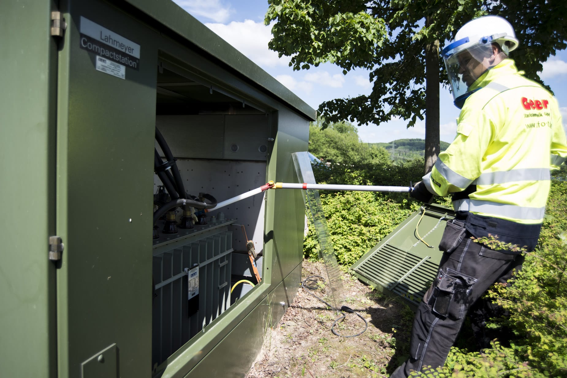Trafos / Trafostationen Servicetechniker bei Wartungsarbeiten an einer Trafostation